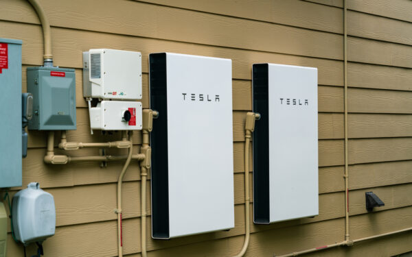 Two Tesla home battery units installed on a wall