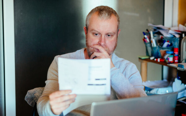 Man reading energy bill at desk