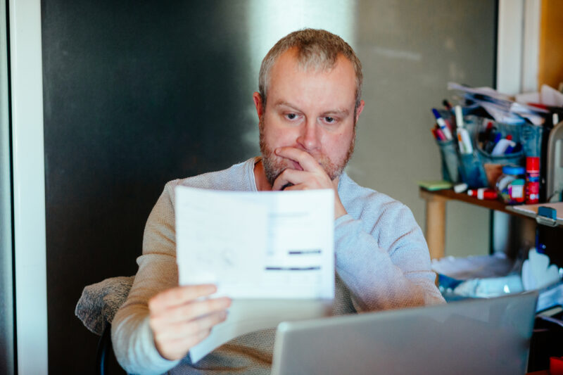Man reading energy bill at desk