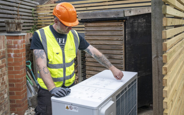 Man installing air source heat pump