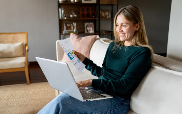 Woman switching energy suppliers on laptop at home