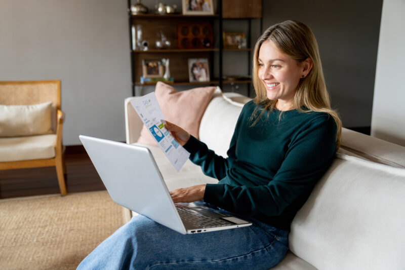 Woman switching energy suppliers on laptop at home