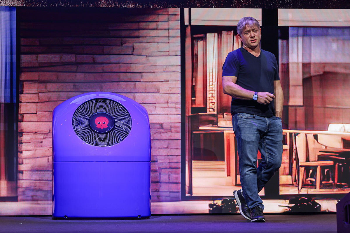 Man presenting next to purple heat pump.