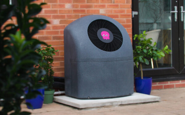 Air source heat pump near brick wall