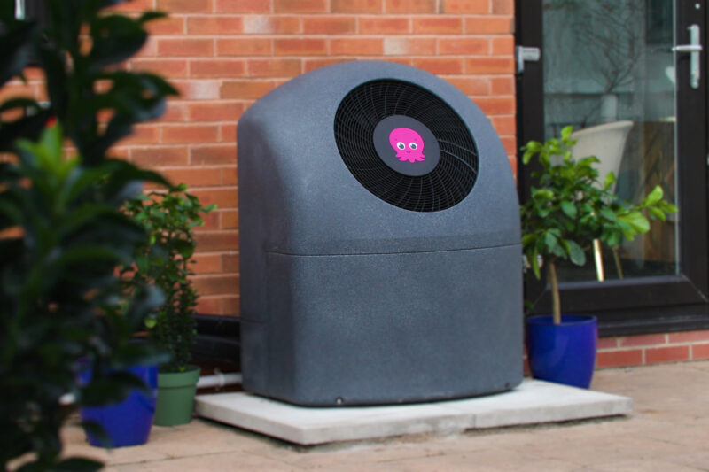 Air source heat pump near brick wall