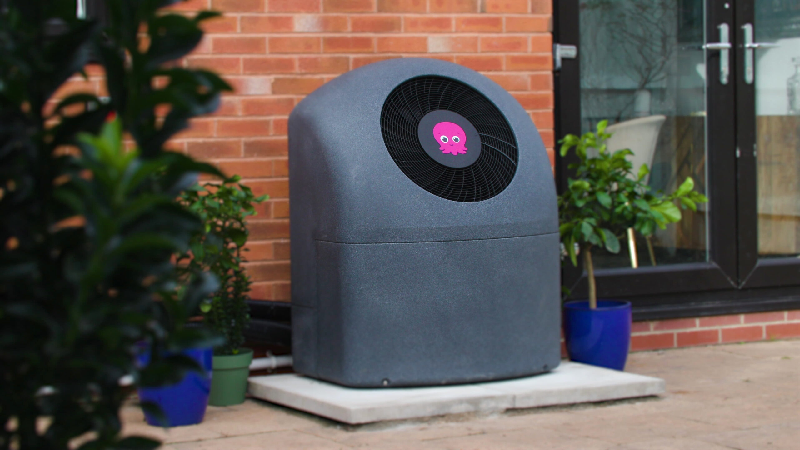Air source heat pump near brick wall