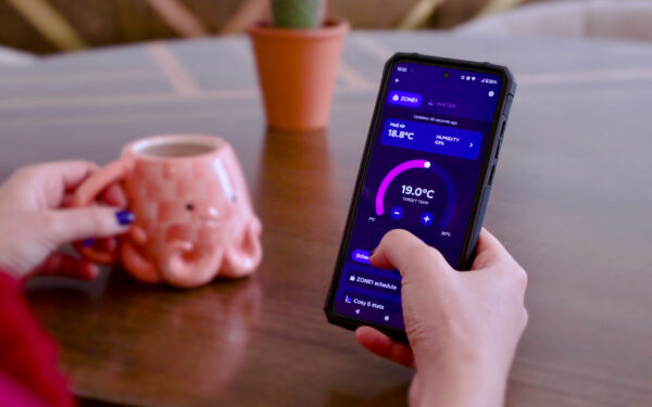 Person using a smartphone app to control their heat pump settings.