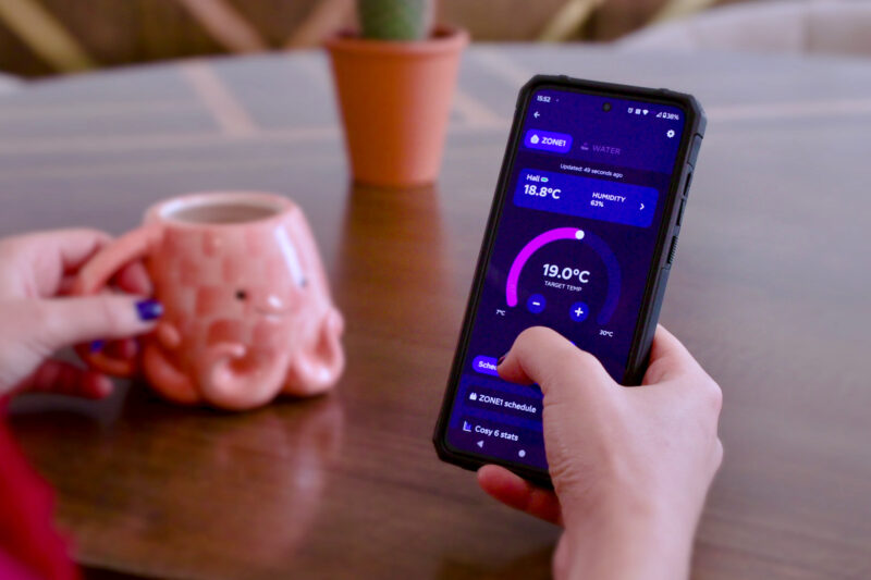 Person using a smartphone app to control their heat pump settings.