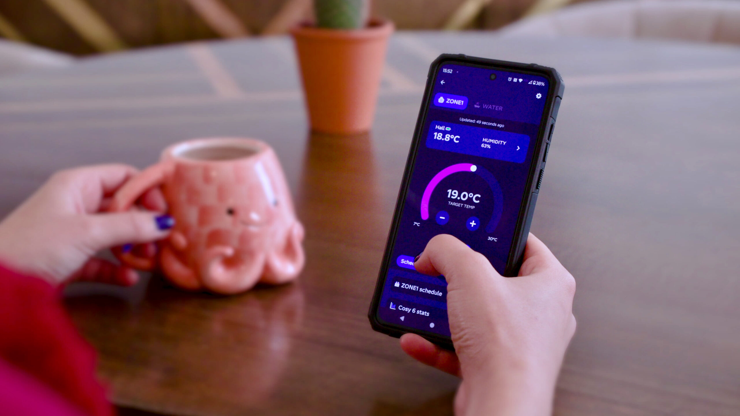 Person using a smartphone app to control their heat pump settings.