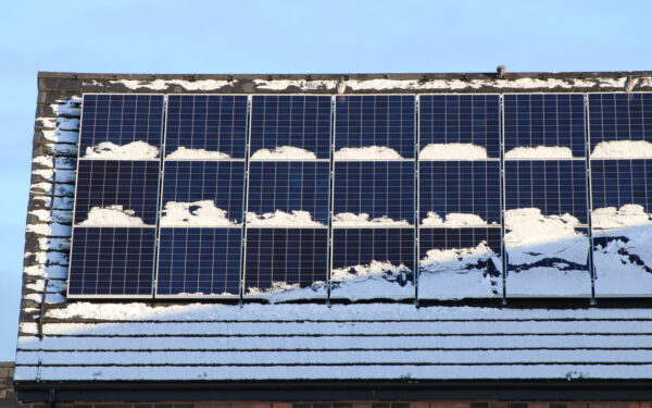 Snow-covered solar panels on roof