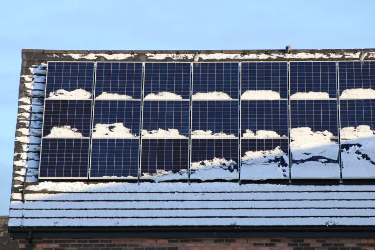 Snow-covered solar panels on roof
