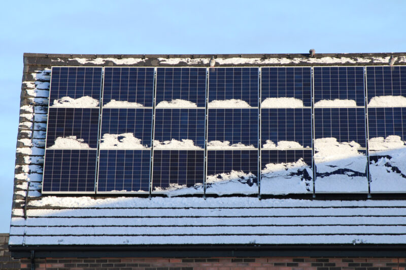 Snow-covered solar panels on roof