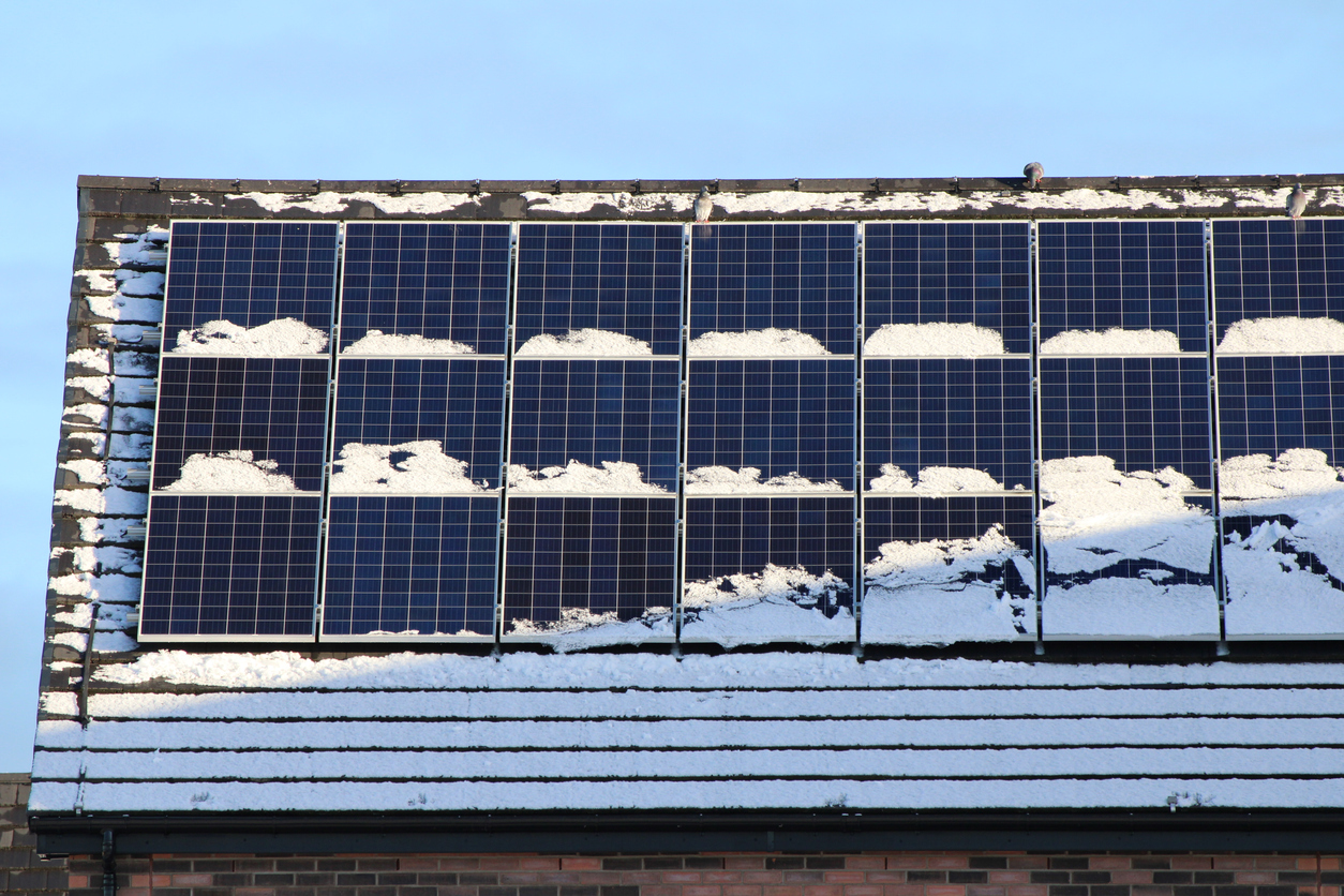 Snow-covered solar panels on roof